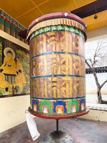 A close-up of a traditional Tibetan prayer wheel in Spiti. The intricate details and vibrant colors represent the rich cultural and spiritual heritage of the region.