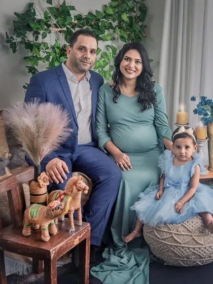 A formal family portrait taken in the bohemian studio setup. This image shows the versatility of the space, perfect for capturing both candid moments and more traditional family photos.