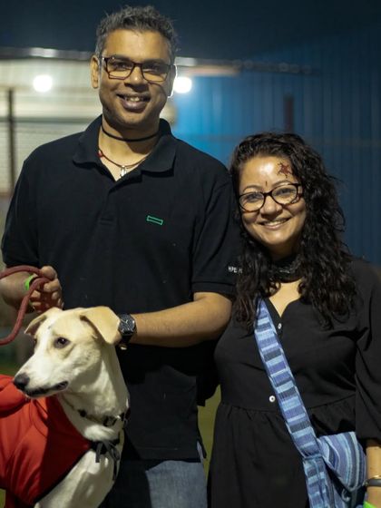 A smiling couple with their indie dog at our night-time Halloween event. I ensure the lighting and ambiance are perfect for an evening party.