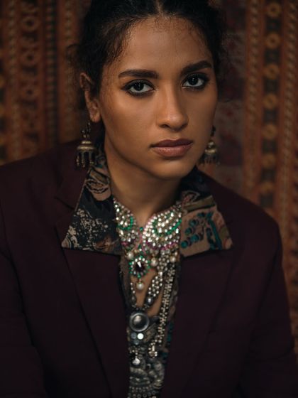 Another variation from the "Jewels laden regally" series, this shot has a slightly softer, more inquisitive feel. The lighting and composition remain focused on the opulent styling and the rich, moody atmosphere of the shoot.