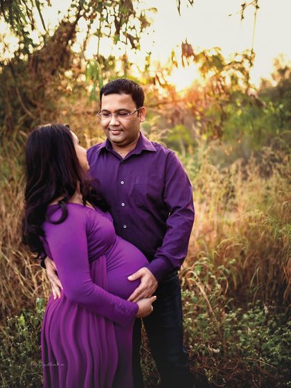 A beautiful moment of connection between an expecting couple, captured during golden hour. The warm light and natural setting create a romantic and intimate atmosphere for this outdoor maternity portrait.