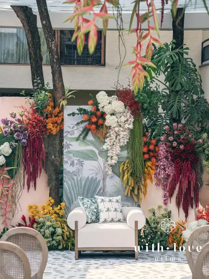 The 'Garden of Gaia' theme brought to life for a vibrant baby shower. This lush floral backdrop, bursting with tropical blooms and rich textures, transforms a backyard into a sacred, celebratory space for the mom-to-be.