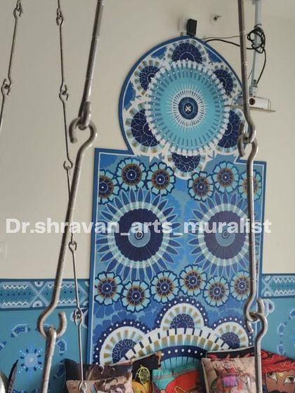 A Moroccan-style mural using a monochrome blue theme. The intricate patterns create a soothing and royal ambiance for this seating area.