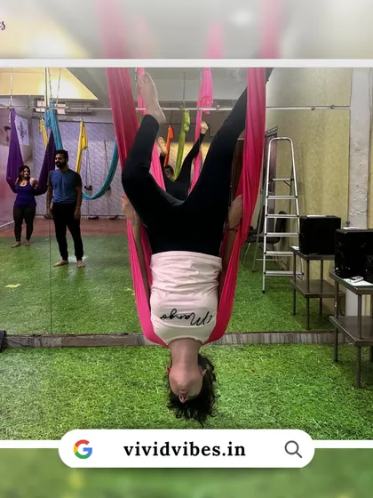 Aerial yoga is a mental practice too. This image shows a student in a deep inversion, a pose that requires focus and trust.