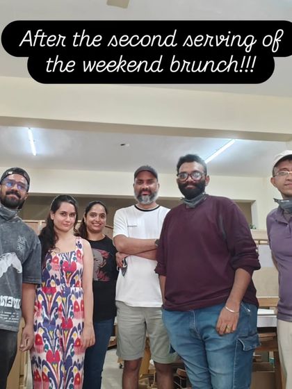 The happy crew after a full weekend of woodworking. Everyone is holding up the projects they completed, feeling accomplished and ready for a rest.