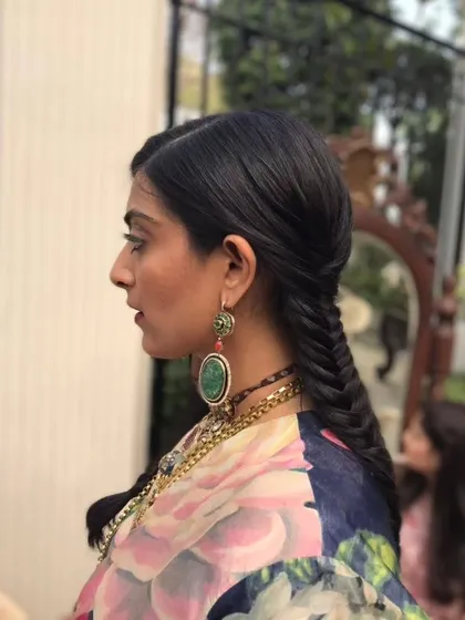 A sleek and polished fishtail braid. This is a great alternative to a bun, offering a chic and modern look that pairs beautifully with both traditional and contemporary outfits.
