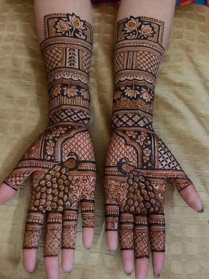 A graceful design featuring the national bird, the peacock, with its feathers beautifully detailed on the palms, complemented by lotus motifs.