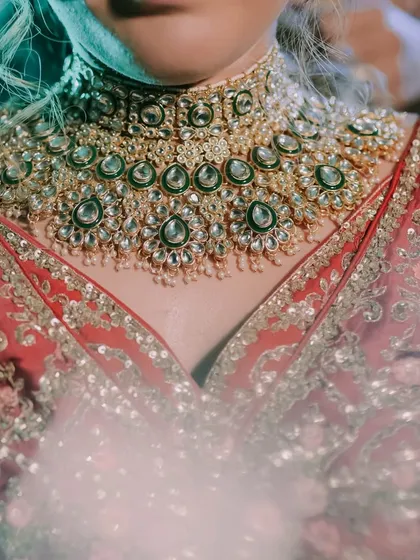 A detailed shot of the bride's stunning Polki and emerald necklace. We focus on capturing these important details that complete the bridal look and hold sentimental value.