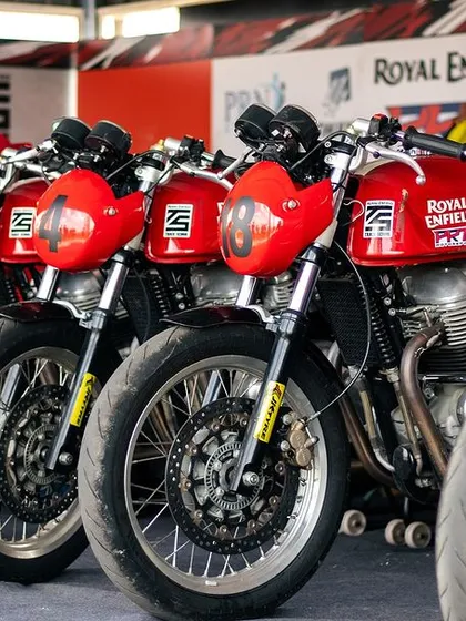 A lineup of Royal Enfield GT 650s in the pit garage.
