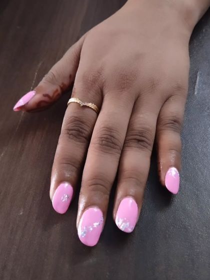 A pretty pink gel polish with silver foil flakes. This is an easy way to add a bit of texture and shine to a simple color, giving it a more custom feel.
