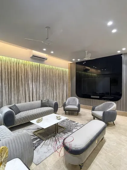 This shot captures the full living and dining space, showcasing the open-plan layout. The consistent color scheme and materials create a unified and expansive feel, perfect for modern family living.