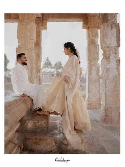 A candid moment of conversation between the couple as they sit on the ancient stone steps of the temple.