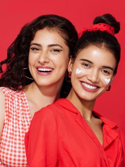 Another look from the Aqualogica campaign, showing how the simple red and white outfits create a clean, eye-catching visual against the red backdrop.