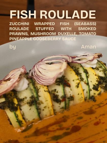 A beautiful Zucchini-Wrapped Fish Roulade by Chef Aman, stuffed with smoked prawns and served in a tomato pineapple gooseberry sauce.