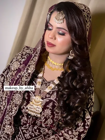 A close-up of this bride's beautiful makeup, featuring a shimmery eye and a soft, matte lip.