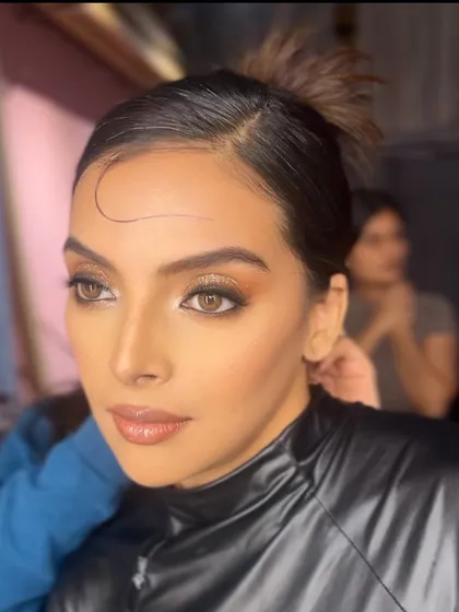A candid, behind-the-scenes shot of the shimmery eye look, showing the makeup in a more natural, unposed setting.