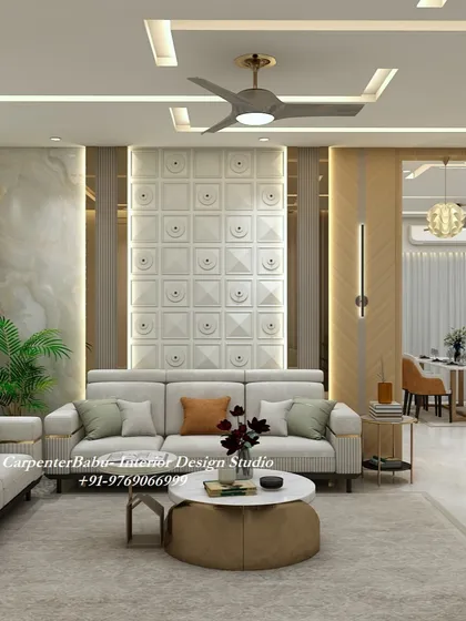 This living room features a stunning feature wall with 3D square panels. The neutral sofa is accented with orange and green cushions, adding a subtle pop of color.