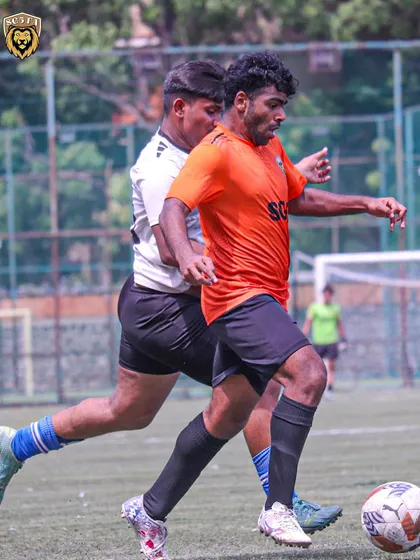 An intense moment from a First Division match, with our player shielding the ball from an opponent.