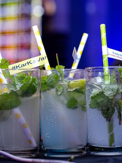 A lineup of refreshing Virgin Mojitos, customized for a wedding with '#KarkaVar' tags. I can personalize drinks and details to match your event's theme and hashtags.