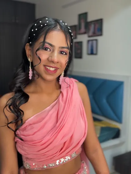 A full-face view showing her radiant smile and the pretty pink tones of her makeup.