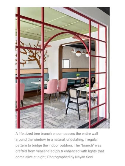 As seen in Elle Decor, this life-sized tree branch sculpture creates a natural, undulating pattern on the wall. It's a key feature that brings a sense of wonder and organic artistry to the dining experience.