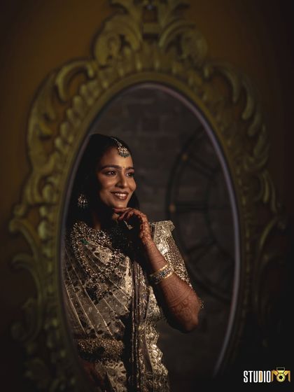 A beautiful mirror portrait of Sruthi. The reflection captures her joy and the stunning details of her reception look.
