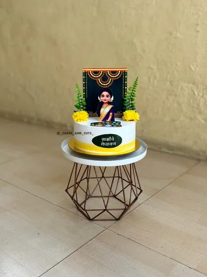 This cake was designed for a Kelvan ceremony, a traditional Maharashtrian pre-wedding event. We created a custom topper featuring the bride-to-be in a beautiful saree to match the cultural significance of the day.