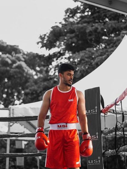 A focused stance in the ring. This black and white shot captures the intensity and mindset required for competitive boxing.