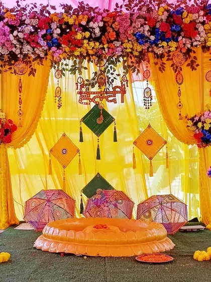 The Haldi ceremony is all about joy and vibrant colors. We designed this beautiful and traditional Haldi decor, using a classic yellow theme with marigolds, ethnic umbrellas, and elegant drapery to create a picture-perfect setting.
