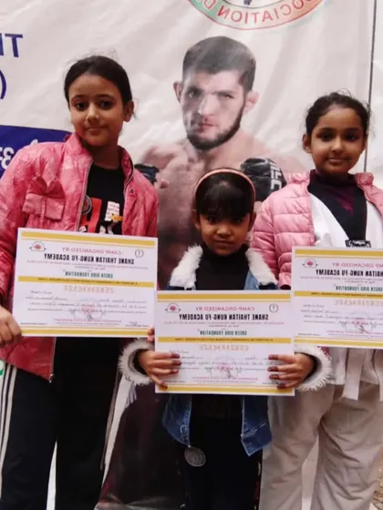 The next generation of champions. These young girls proudly hold their certificates after a successful event. They are learning self-defense and discipline from an early age.