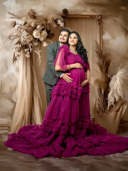 The couple together, looking towards the future. The partner stands behind, creating a portrait that feels both grand and intimate, with the magenta gown as the centerpiece.
