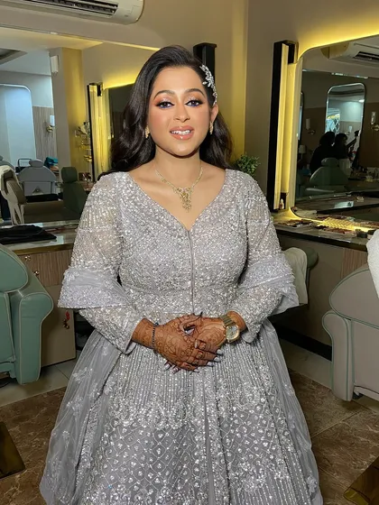 A full-length view of her beautiful silver-grey gown.