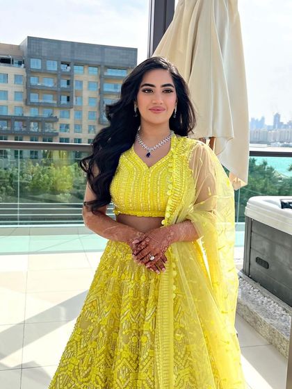 A portrait of the bride, her long, dark waves and yellow outfit creating a beautiful, sunny look.