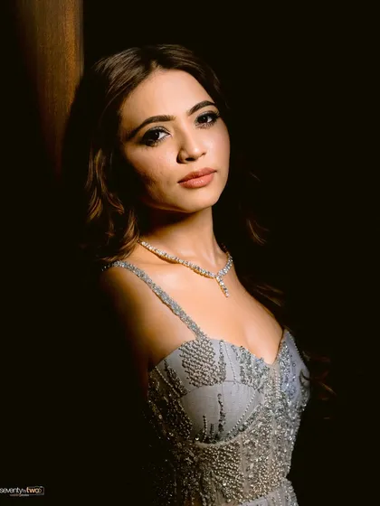 A night draped in shimmer and mischief. This dramatic portrait captures the bride's stunning look for her cocktail party.