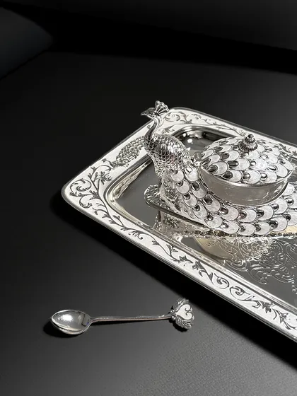 Sometimes, a single piece can define the mood of an entire room. This exquisite enamel peacock bowl and tray set, with its intricate silver detailing, is designed to be that piece, offering a touch of majesty and timeless elegance.