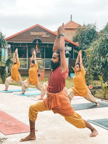 We take our practice into the embrace of nature whenever we can. Here, I am leading a class in Virabhadrasana I (Warrior I Pose) in the ashram garden. Practicing outdoors reminds us that we are part of something larger than ourselves, grounding our energy and strengthening our spirit.