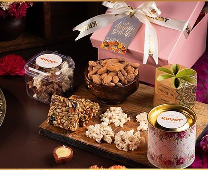 The Pretty Pink Festive Indulgence Box for Diwali, containing cookies, almonds, granola bars, and more. A thoughtful and wholesome gift.