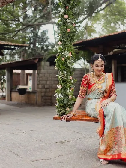 Our iconic floral swing is more than just a seat; it’s a frame for grace and elegance. Here, a bride finds a quiet moment of reflection, surrounded by the gentle embrace of nature and the timeless charm of our courtyards.
