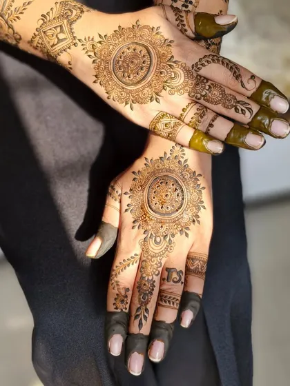 An elegant and minimalist engagement design. This style features a beautiful mandala on the back of the hand with delicate patterns on the fingers.
