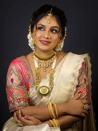 A smiling portrait of the bride, showing how the jewellery and makeup come together to create a look of pure joy and elegance.