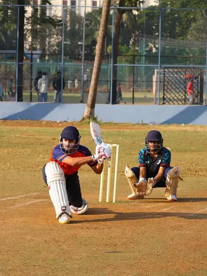 A batsman playing a sweep shot during the practice match, showcasing a full range of strokes.