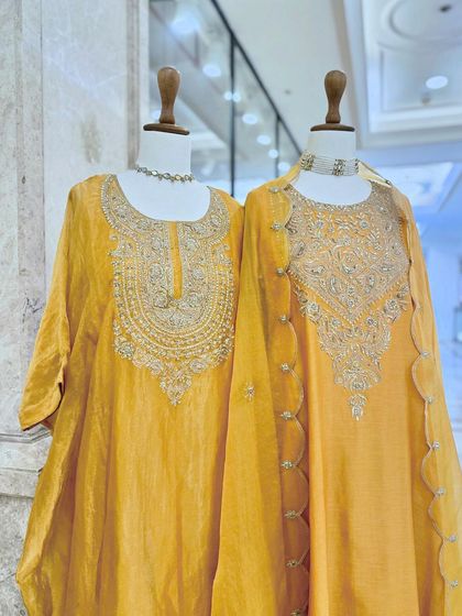 Two stunning yellow kurta sets with intricate silver embroidery, one with a round neck and the other with a V-neck, showcasing versatile festive options.