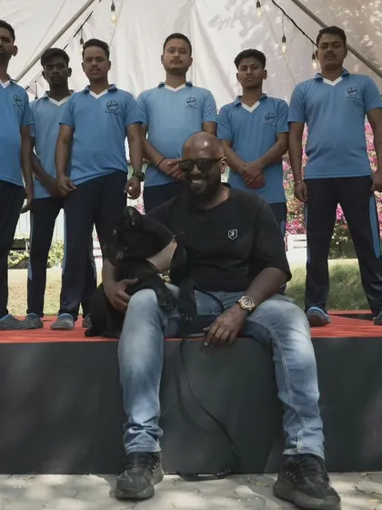 Posing with my team and one of my dogs. It takes a dedicated team to run a successful board and train facility and give every dog the attention it needs.
