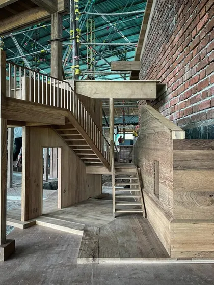 We don't just draw plans; we build them. This full-scale wooden model of a staircase, constructed on-site, allows us to study the proportions, materials, and feel of a design in a way that drawings cannot. It is a critical part of our hands-on process.