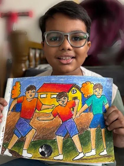A student holds his memory drawing of boys playing football. Capturing action and emotion is a skill we develop for our exam preparation.