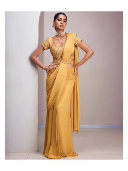 A little sunshine and a lot of confidence. This pre-draped saree in a vibrant mustard yellow features a beautifully embroidered blouse and a sleek, modern silhouette.