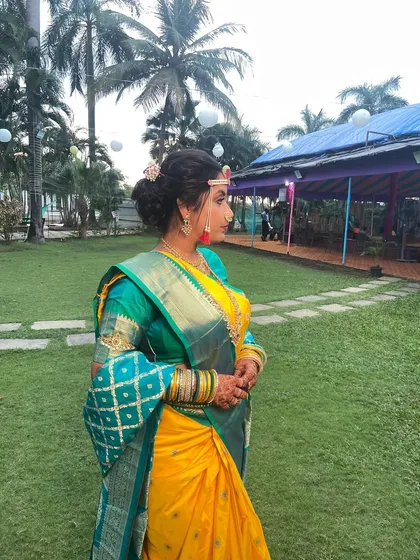 A side profile showcasing the elegant bridal bun and how the makeup enhances her features, creating a beautiful silhouette.