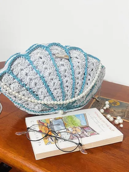 Bringing beachy vibes to you with this custom Seashell Bag. I crafted this piece with delicate pearl details and a silver chain strap, making it a truly unique accessory. It’s perfect for when you want to carry a little bit of the ocean with you.