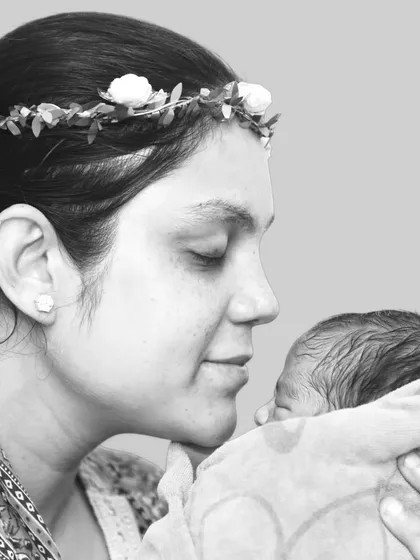 There is nothing more powerful than a mother's love. This black and white portrait focuses on the quiet, tender connection between a new mother and her baby, a timeless memory captured forever.