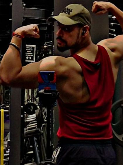 I don't believe in taking weekends off from my goals. This back double biceps pose shows the kind of definition that comes from year-round dedication.